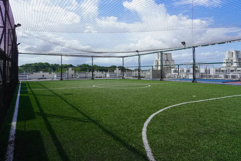 Open-air clean and well-maintained futsal court located on rooftop of the Singapore G building, accessible to staff, tenants and friends of staff and tenants